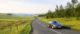 black car driving on road